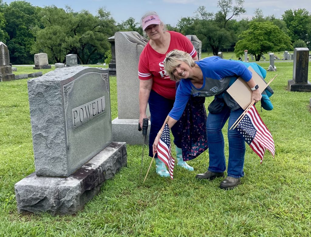 Chapter Regent Becky Gunn and Vice Regent Vicki Tolleson placing flags on Veterans graves at Elmwood Cemetery on Memorial Day weekend.