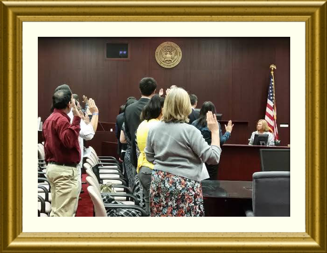 New Citizens Stand, Pledging their Allegiance in a Naturalization Ceremony at the Federal Courthouse in Greeneville, TN